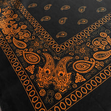 Load image into Gallery viewer, Black bandana with orange floral paisley print close-up view at an angle